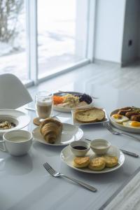 a white table with plates of food on it at Спа-готель ПОЛО-МЕДЛАЙФ in Kremenchuk