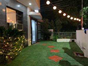 a backyard with a christmas tree and lights at THE REJOICE VENTURE in Gurgaon