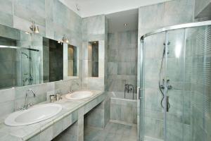 a bathroom with two sinks and a shower at Zois Apartments in Ljubljana