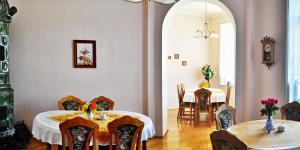 a dining room with two tables and two chairs at Pension Habermannova Vila in Bludov