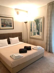 a bedroom with a bed with two towels on it at Villasonboard Vouliagmeni Condo Lux & Comfy Riviera & beach in Athens