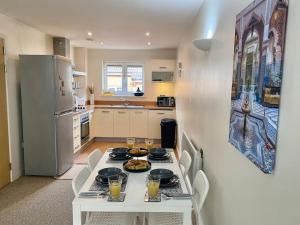 a kitchen with a white table with food on it at Moroccan Inspired Northampton Apartment in Northampton