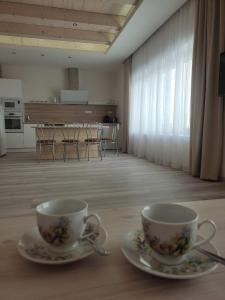 two coffee cups on a table in a room at Ubytovanie pre Vás in Poprad