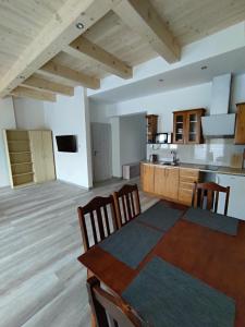 a kitchen and dining room with a table and chairs at Ubytovanie pre Vás in Poprad