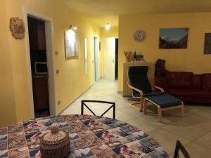 ein Wohnzimmer mit einem Tisch und einem Sofa in der Unterkunft casa Olivieri in Carisolo