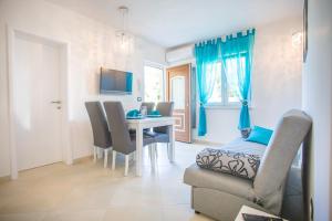 a living room with a dining room table and chairs at Villa Birikina apartments with pool in Nova Vas
