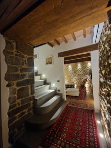 a staircase in a house with a stone wall at Casa Papalino in Larciano