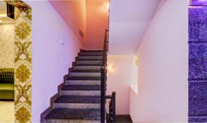 a staircase in a house with purple walls at Treebo Three Street Inn in Bengaluru