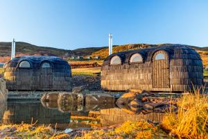 two domed buildings are sitting in the water at Bracken Hide Hotel in Portree