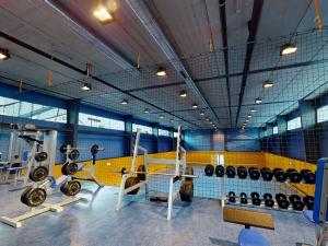 a gym with a lot of equipment in it at Hotel Ski Austria St.Christoph a.A. in Sankt Christoph am Arlberg
