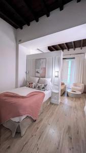 a bedroom with a large white bed in a room at Casa Bailen Sevilla in Seville