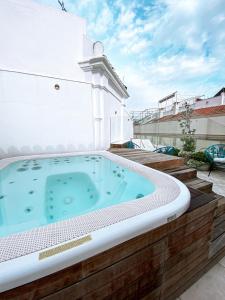a hot tub on the roof of a house at Casa Bailen Sevilla in Seville