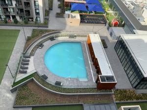 an overhead view of a swimming pool on a building at M-city Apartment - Executive Twin King Ensuites - Fully equipped - Free Parking, fast Wifi, smart TV, Netflix, complementary drinks & amenities - M-city shopping centre Clayton 3168 in Clayton North