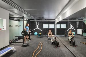 a group of women in a gym with weights at Appartamenti Les Viles in La Villa