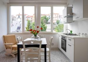 une cuisine avec une table et un vase de fleurs. dans l'établissement B & B L'ABBRACCIO, à Agnone