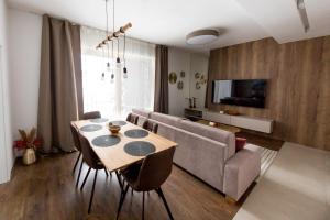 a living room with a table and a couch at Apartmán Snow in Oravská Lesná