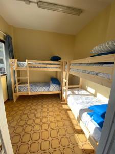 two bunk beds in a small room with at Lo Bec in Ronco Canavese