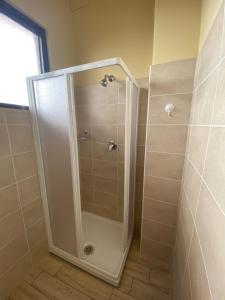 a shower with a glass door in a bathroom at Lo Bec in Ronco Canavese