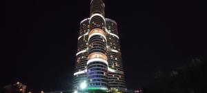 a tall building with lights on it at night at Tips For istanbul in Istanbul