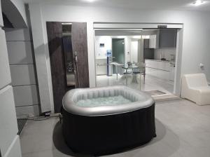 a large bath tub in a room with a kitchen at Alpha Delta Pool Suite in Paleo Tsifliki