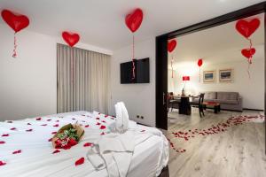 a bedroom with a bed with red hearts on it at Hotel Madisson Inn Luxury By GEH Suites in Bogotá +74 photos