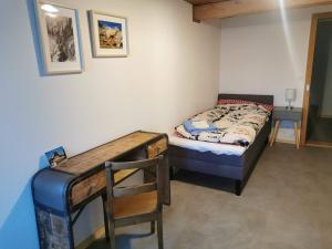 a small bedroom with a bed and a desk at Gasthof Kreuz Marbach in Marbach