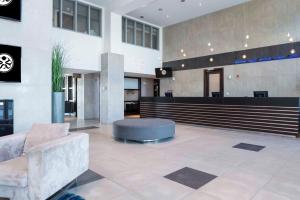 a lobby of a building with a waiting area at Sandman Signature Prince George Hotel in Prince George