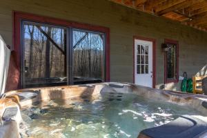 a hot tub in front of a house at Laurel Creek Lodge in Banner Elk