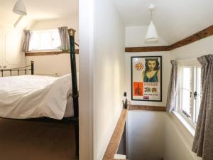 a bedroom with a bed and a window at 48 Polecat Cottages in Lewes