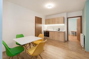 una cucina e una sala da pranzo con tavolo e sedie di Minimalist styled TINY AP @New York Café a Budapest