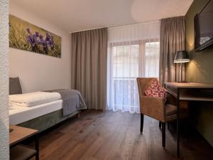 Łóżko lub łóżka w pokoju w obiekcie Panoramahotel Fliesserhof