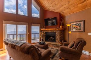 a living room with two couches and a fireplace at Grand Panorama in Banner Elk
