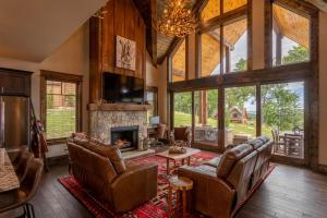 a living room with leather furniture and a fireplace at Eagles Overlook at Eagles Nest in Elk Park