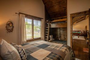 a bedroom with a bed and a ladder in a room at Eagles Overlook at Eagles Nest in Elk Park