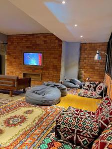 a living room with three bean bags on the floor at Arch Dormitorio Cenang in Pantai Cenang