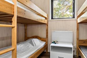 a bedroom with two bunk beds and a desk at First Camp Kolmården-Norrköping in Kolmården