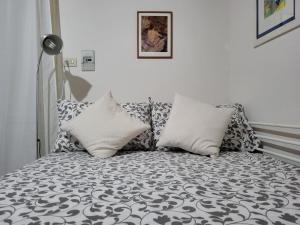 a couch with pillows on it in a room at Casa Minniti in Syracuse