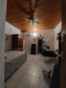 a bedroom with a ceiling fan and a table at Casa Minniti in Syracuse +10 photos