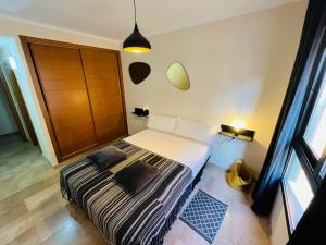 a bedroom with a bed and a large window at La Faroleta Puerto in Denia