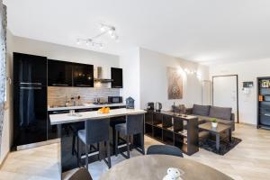 an open kitchen and living room with a couch at Casa Massima Suites in Casamassima
