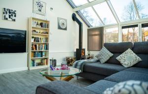 a living room with a couch and a tv at Rivendell Park in Wimborne Minster