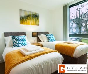 two beds in a room with a window at ByEvo 5 Brabloch - perfect for contractors - Close to GLA in Paisley