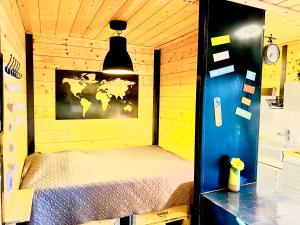 a room with a bed in a wooden cabin at Studio Du Moulin in Saint-Laurent-dʼAndenay