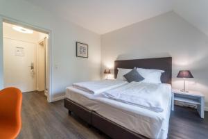 Ein Bett oder Betten in einem Zimmer der Unterkunft Auszeit Hotel Hamburg