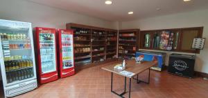 a store with two refrigerators and a table in a room at hotel Pedra Azul ES in Domingos Martins