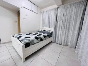 a bedroom with a bed in a white room at New - Luxury Studio 3 Minutes From Beach ! in Tel Aviv