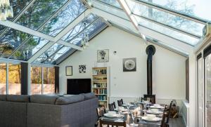 a conservatory with a long table in a living room at Rivendell Park in Wimborne Minster