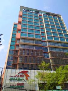 Un palazzo alto con un cartello sul lato. di FARS Hotel & Resorts - BAR-Buffet-Pool-SPA a Dhaka
