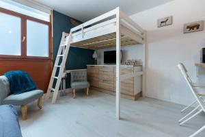 a bedroom with a bunk bed and a desk at L'Ostalet in Saint-Lary-Soulan
