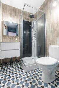 a bathroom with a shower and a toilet and a sink at L'Ostalet in Saint-Lary-Soulan